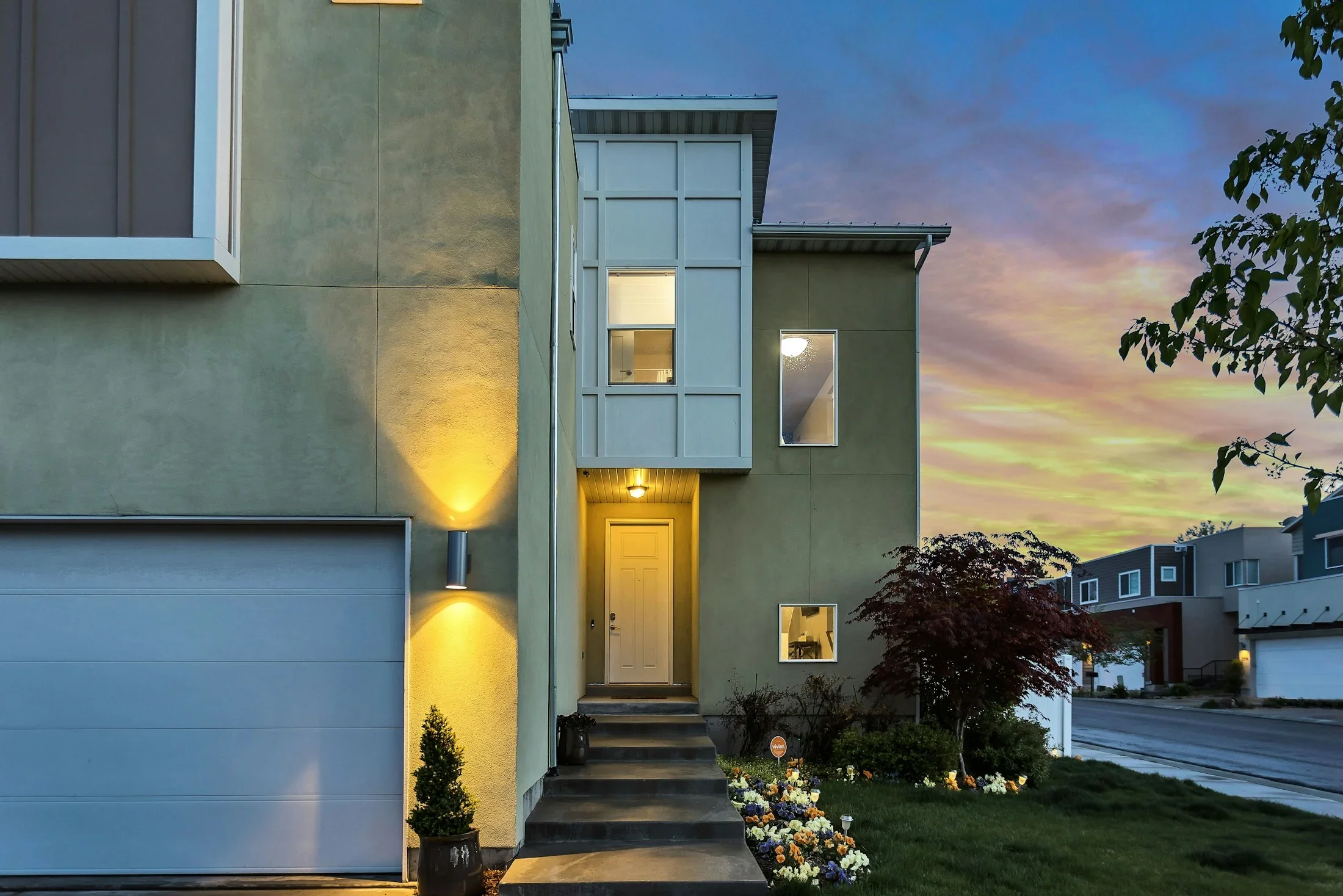 A modern South Salt Lake home with a landscaped entry at sunset