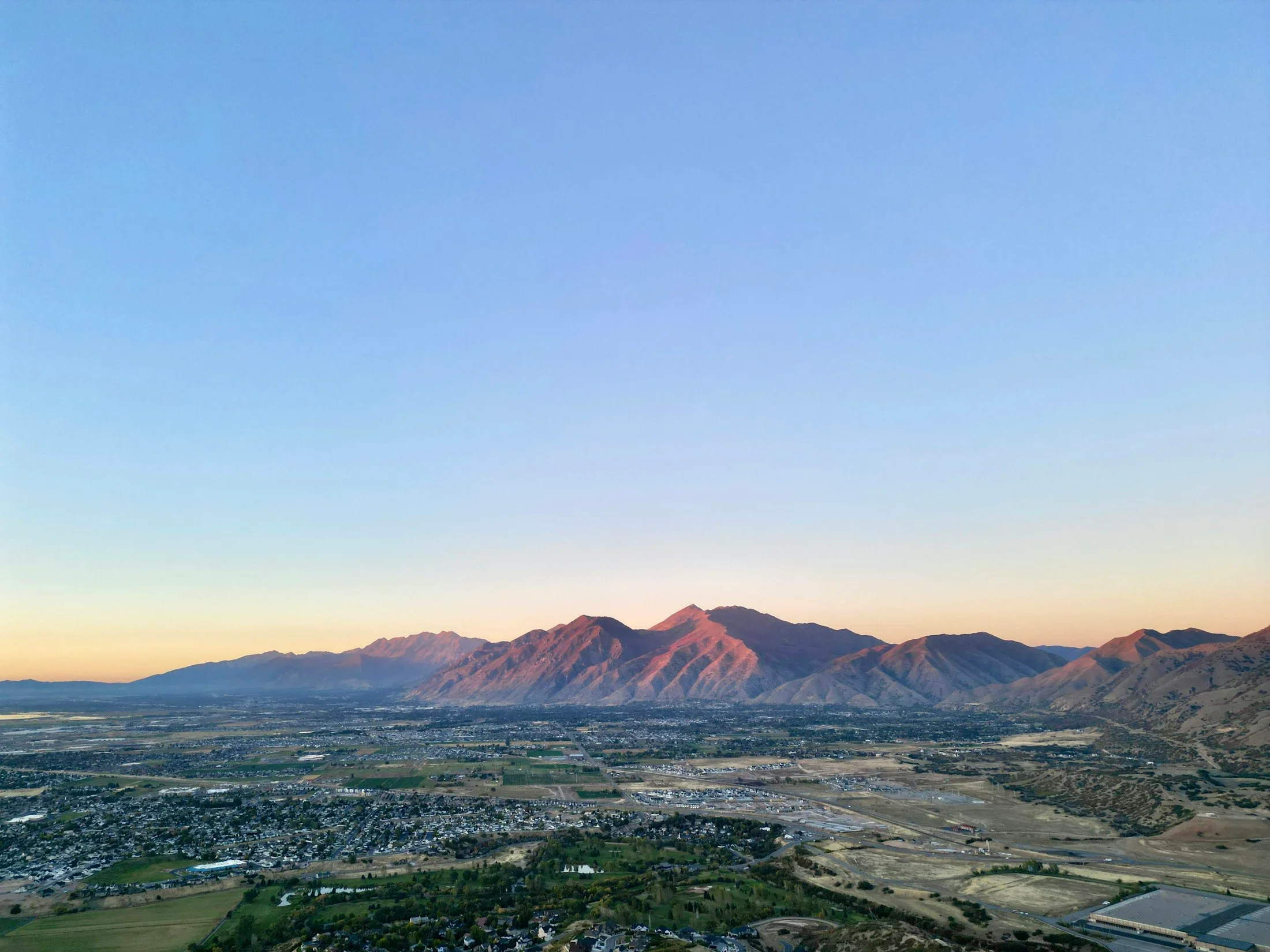 Spanish Fork neighborhoods and Utah Valley mountains at sunset